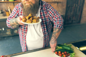 Starving thick guy enjoying smell of unhealthy food